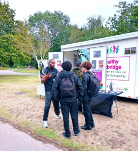 Two young boys speaking to Via worker