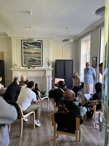 A group of people at Passmores House open day experiencing a talk